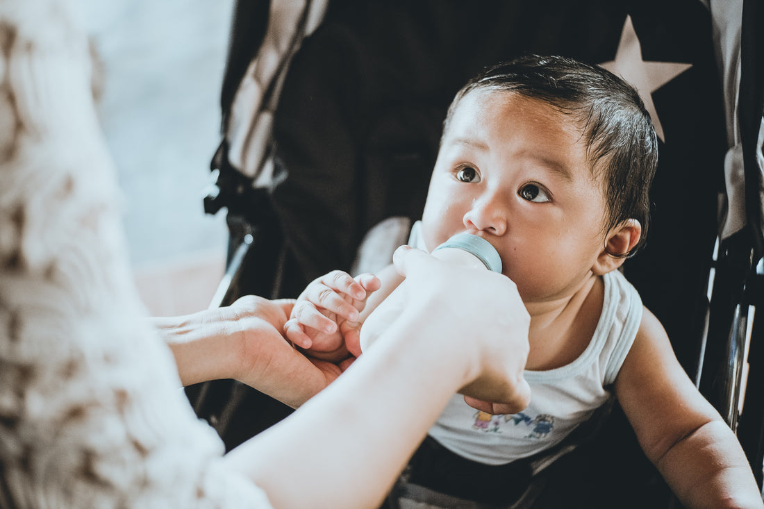 Littorary - Baby feeding from bottle - Rainier Ridao